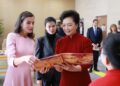 Peng Liyuan and Queen Letizia of Spain visit a disability service center in Beijing