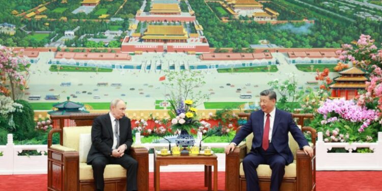 Xi Jinping and Vladimir Putin talk over tea in Beijing